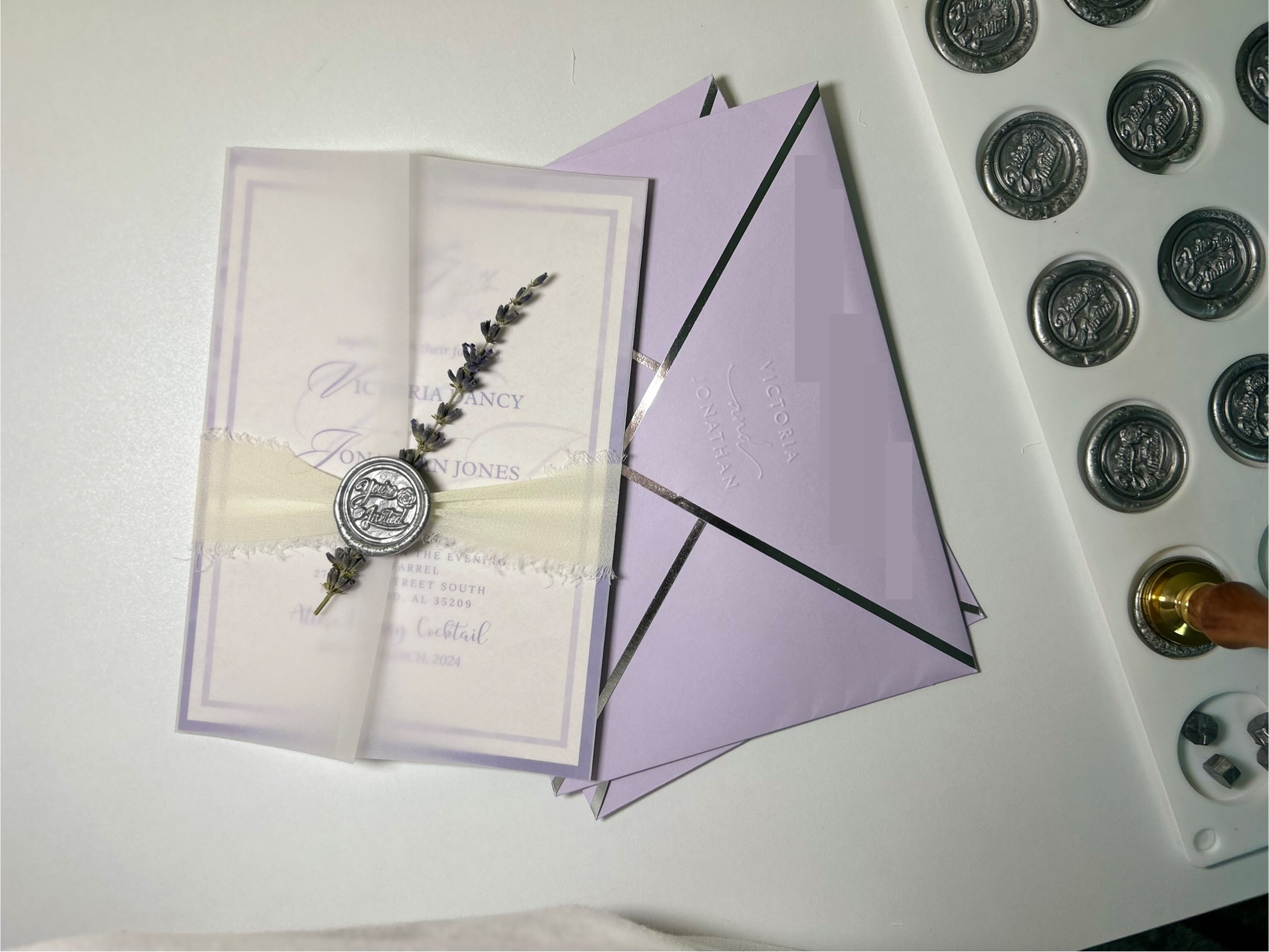 Original lavender wedding invitation suite designed by Ké.B, with translucent vellum, ribbon, wax-seal and lavender envelopes
