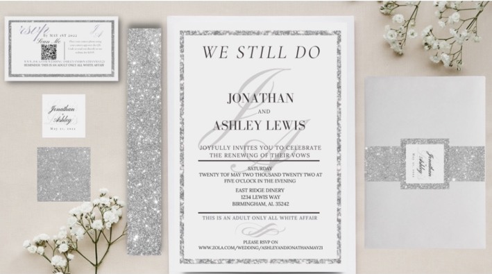 White and silver vow renewal invitation suite and coordinated stationery laid out together